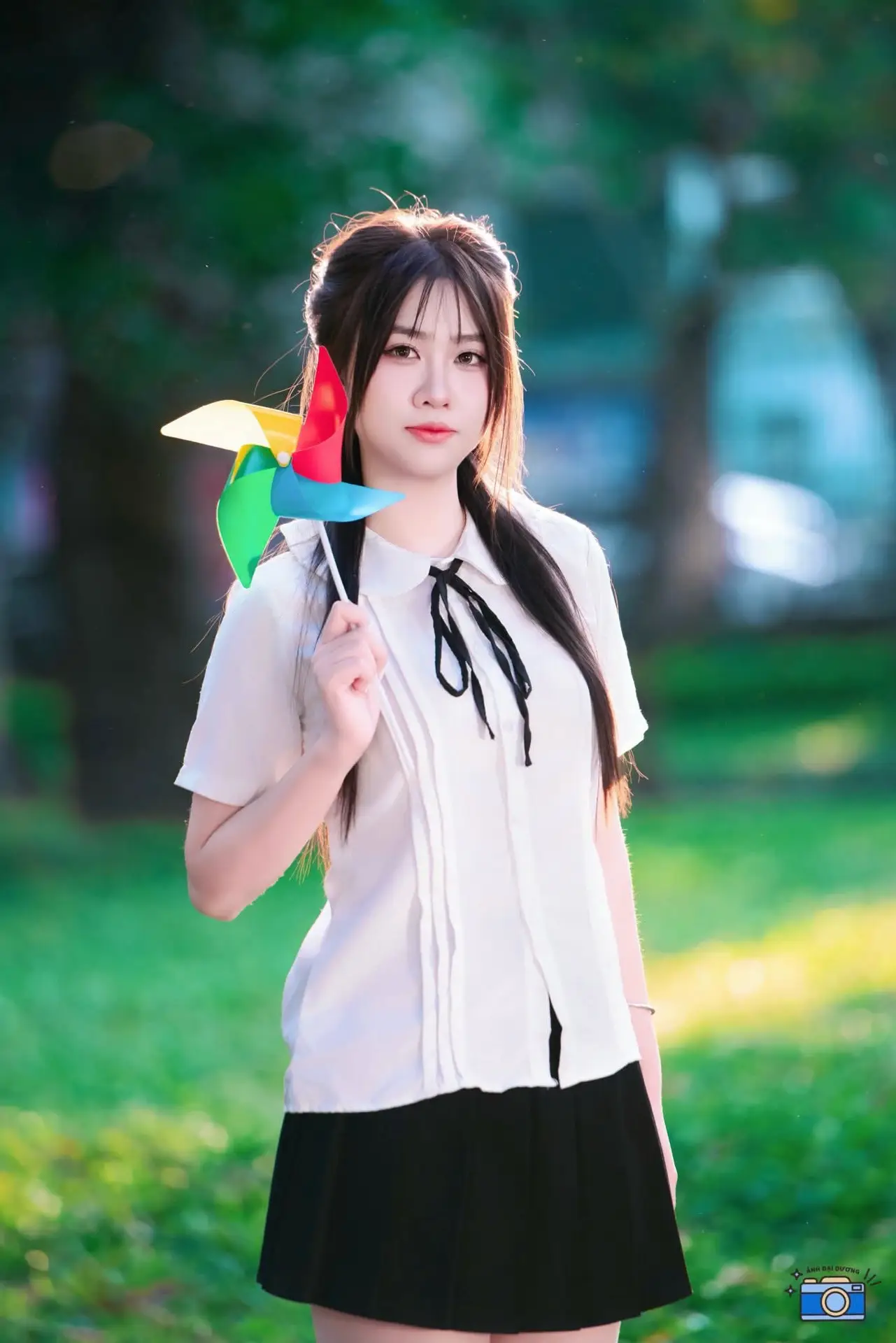 Radiant Youth: Vietnamese Girl's Bright Smile with Pinwheel in Golden Sunlight