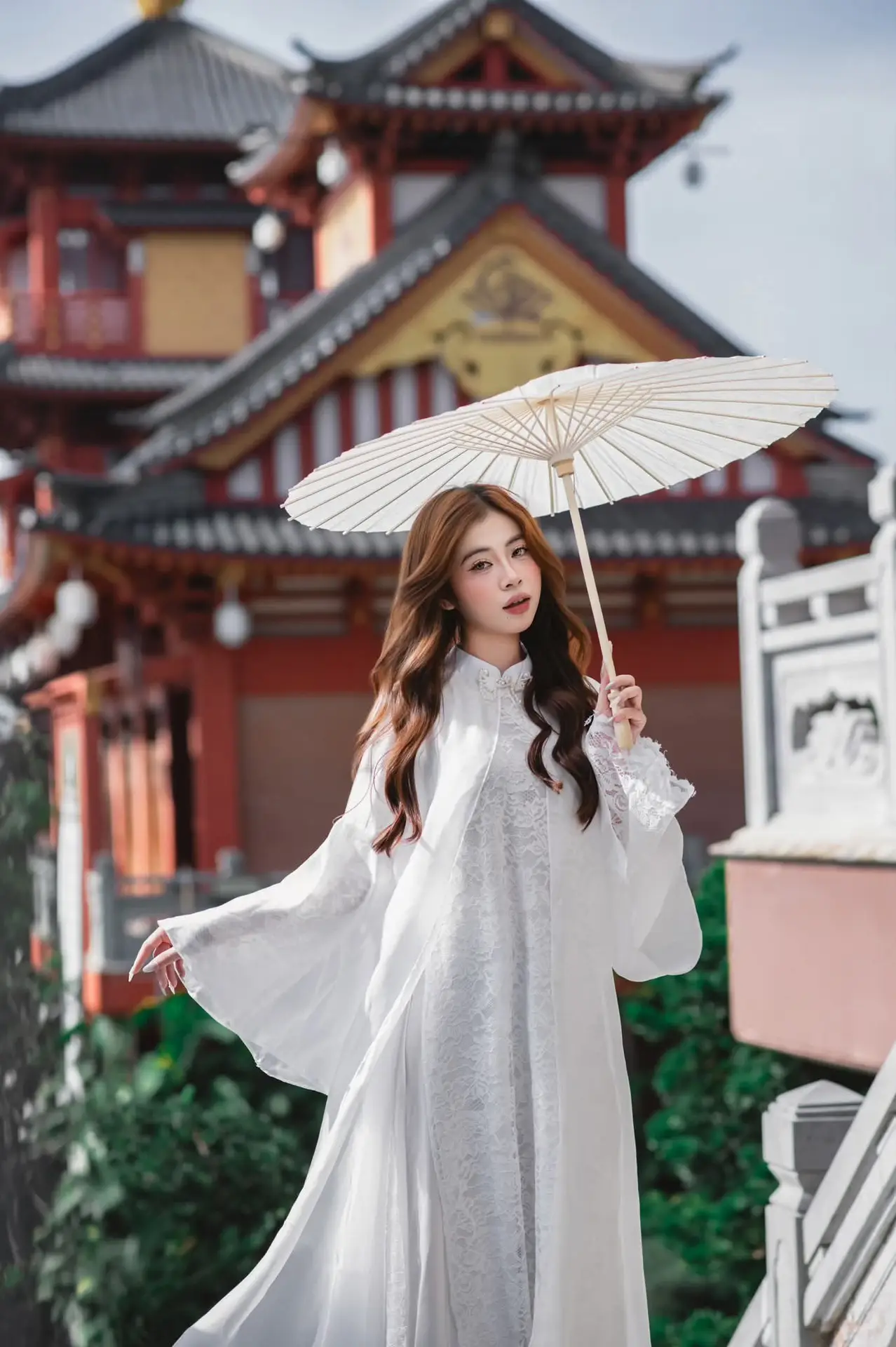 Explore Ethereal Asian Beauty: A Graceful Girl in White Ao Dai Amidst Ancient Oriental Charm