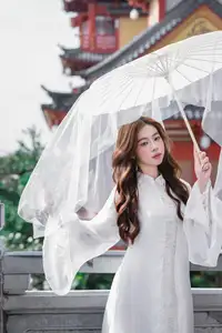 Explore Ethereal Asian Beauty: A Graceful Girl in White Ao Dai Amidst Ancient Oriental Charm - image 4