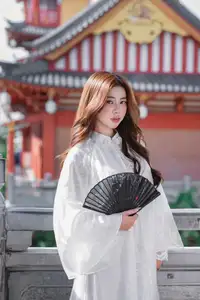 Explore Ethereal Asian Beauty: A Graceful Girl in White Ao Dai Amidst Ancient Oriental Charm - image 2
