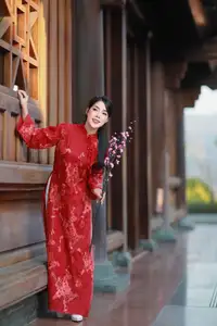 Elegant Red Ao Dai: Vietnamese Beauty with Cherry Blossoms in Ancient Architecture - image 0