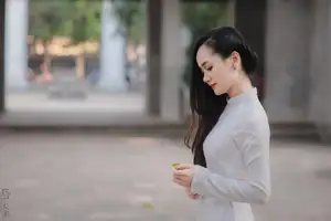 Graceful Vietnamese Girl in White Ao Dai, Radiant Smile at Ancient Site 1000026917 - image 0