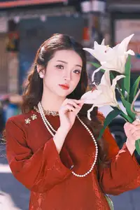Elegant Vietnamese Beauty: A Girl in Red Ao Dai with Lilies Captivates Urban Charm - image 3