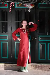 Elegant Vietnamese Beauty: A Girl in Red Ao Dai with Lilies Captivates Urban Charm - image 0