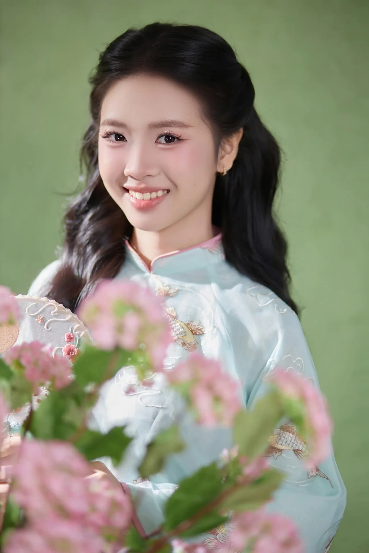 Radiant Elegance in Traditional Blue Attire and Spring Blooms