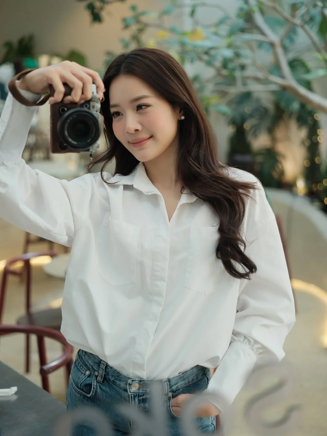 Karen Nguyen radiates effortless elegance in a classic white shirt minimalist look
