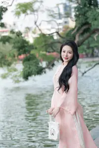Discover the Elegant Charm of Vietnamese Beauty in a Pink Ao Dai by the Serene Lake - image 0