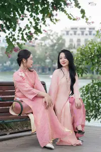 Discover the Elegant Charm of Vietnamese Beauty in a Pink Ao Dai by the Serene Lake - image 1