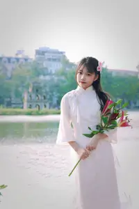 Graceful Vietnamese Girl in White Ao Dai Shines with Traditional Beauty in Old Quarter - image 5