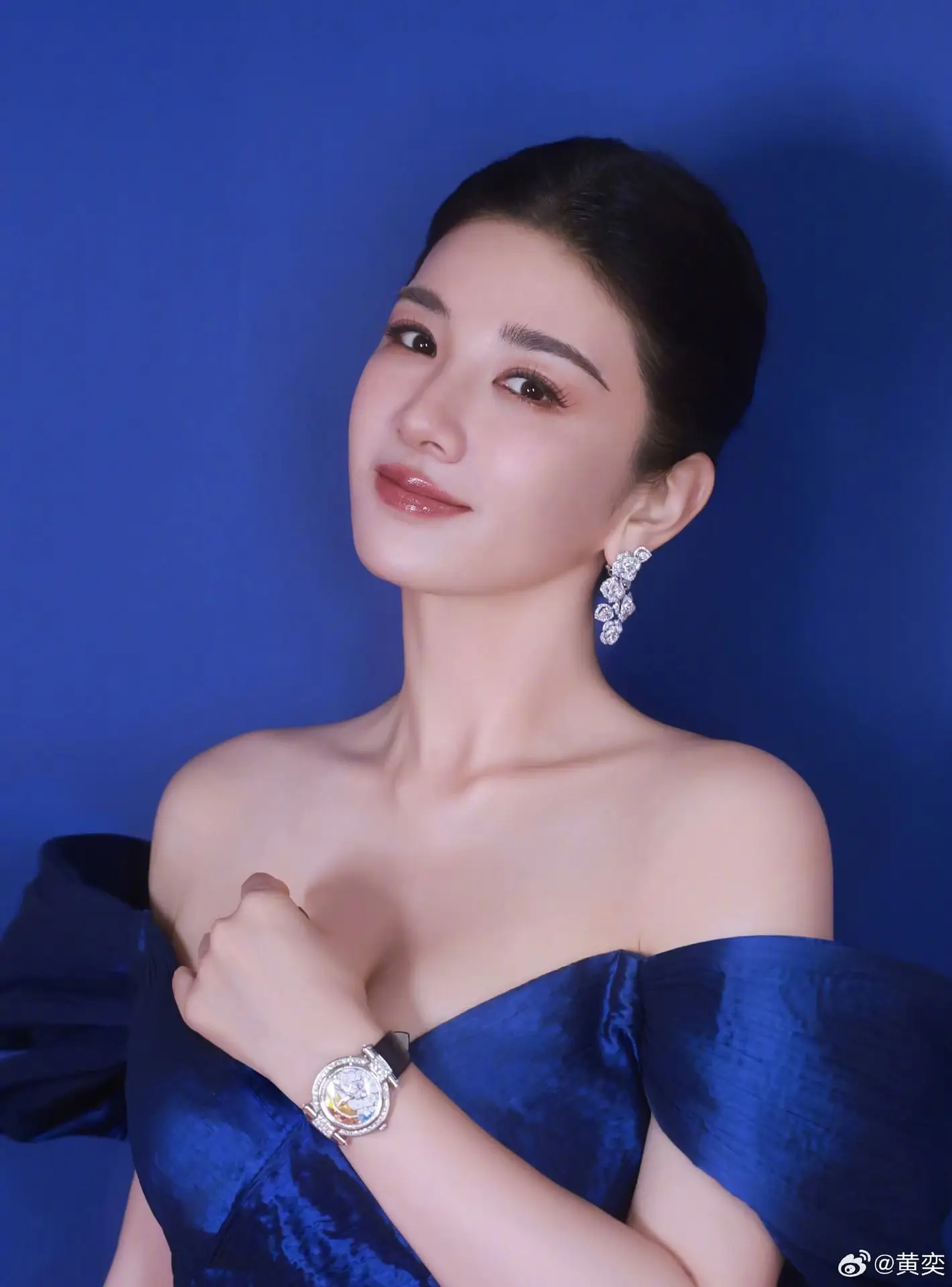 Radiant in Blue: A Woman's Elegant Charm Shines Bright in a Luxurious