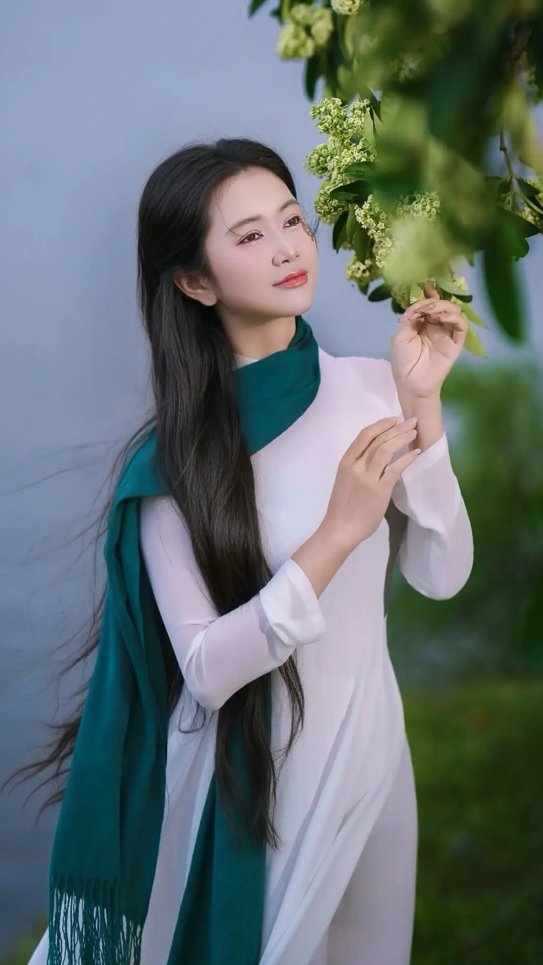 VGU No.172: Captivating Vietnamese Ao Dai Student in a Dreamy Moment, Showcasing Pure Grace Amidst Nature.