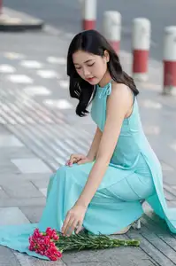 Charming Vietnamese Girl in Turquoise Ao Dai: Elegant Beauty on City Streets - image 7