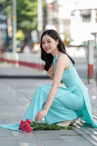 Charming Vietnamese Girl in Turquoise Ao Dai: Elegant Beauty on City Streets - image 2