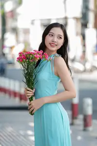 Charming Vietnamese Girl in Turquoise Ao Dai: Elegant Beauty on City Streets - image 4