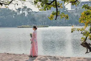 Elegant Asian Beauty: Graceful Woman in Modern Ao Dai by Serene Lakeside - image 5