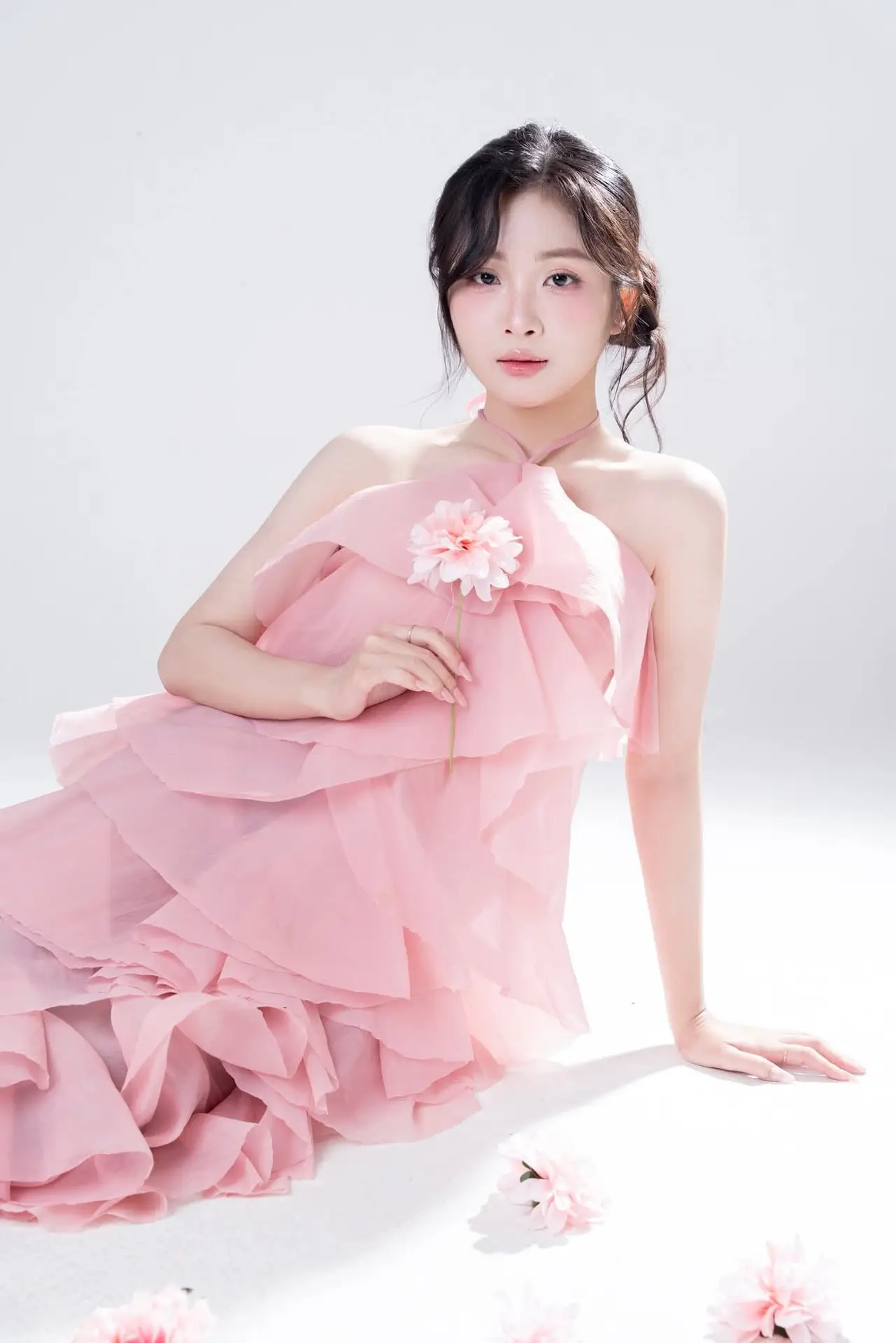 Discover Feminine Elegance: A Girl in a Pink Dress with Pristine Flowers