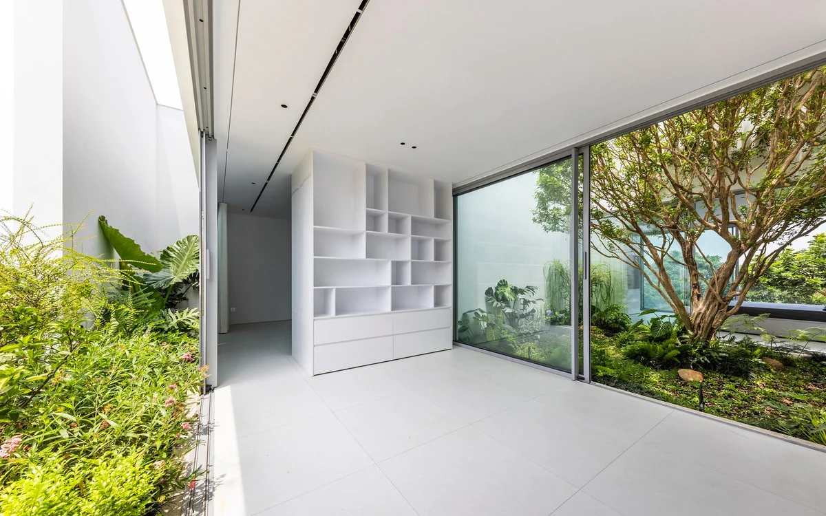 Minimalist White House Design in Ho Chi Minh City: A Serene Urban Oasis Featuring Lush Indoor Greenery and Modern Architecture