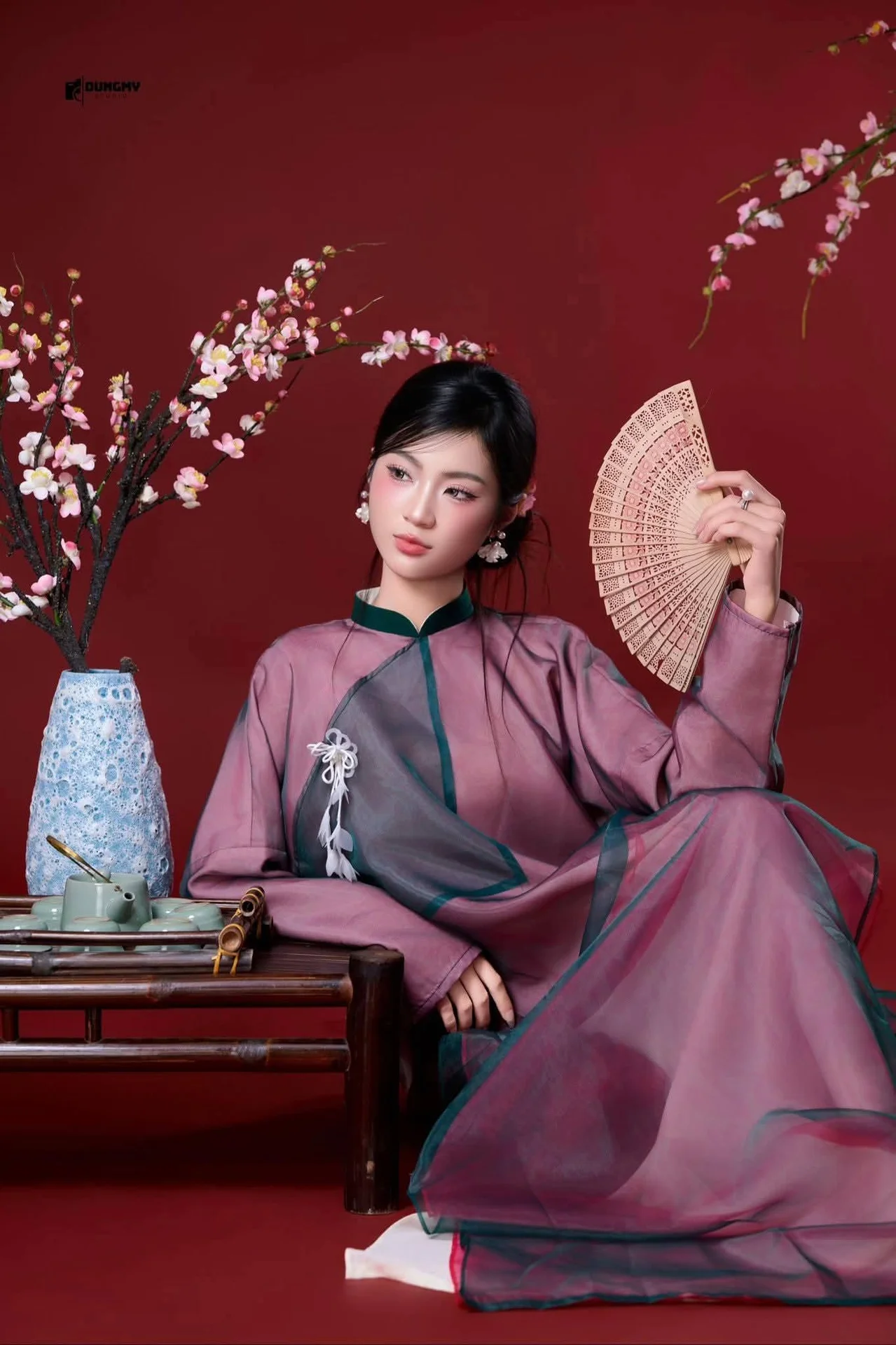 East Asian Grace: Elegant Lady in Traditional Attire & Cherry Blossoms