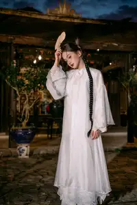 Enchanting Vietnamese Beauty A Girl with Long Braids in Traditional Attire on a Magical Night - image 2