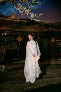 Enchanting Vietnamese Beauty A Girl with Long Braids in Traditional Attire on a Magical Night - image 1