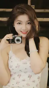 Captivating East Asian Beauty in Floral Slip Dress with Vintage Camera - image 1