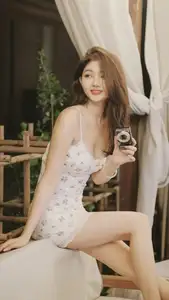 Captivating East Asian Beauty in Floral Slip Dress with Vintage Camera - image 0