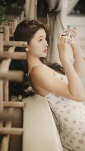 Captivating East Asian Beauty in Floral Slip Dress with Vintage Camera - image 2