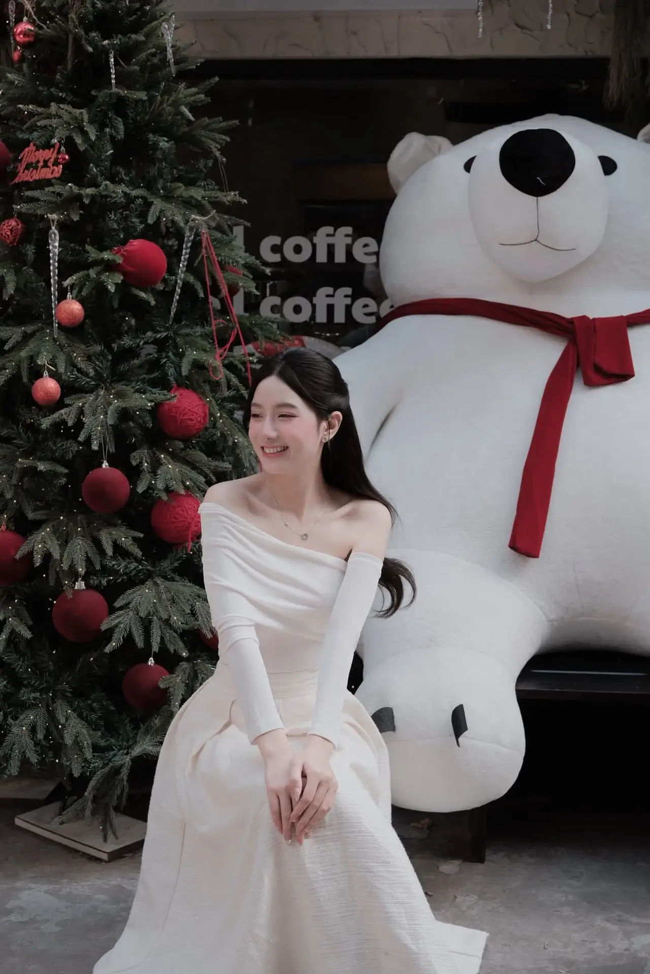 Elegant Girl in Off-Shoulder White Dress Welcoming Christmas, Showcasing Gentle Beauty and Holiday Season Style. 1000027390