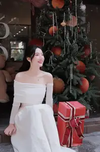 Elegant Girl in Off-Shoulder White Dress Welcoming Christmas, Showcasing Gentle Beauty and Holiday Season Style. 1000027390 - image 8