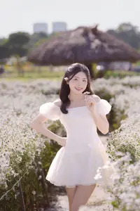 Ethereal Beauty: Young Woman in White Dress with Bouquet Amidst Dreamy Clouds - image 2