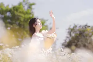 Ethereal Beauty: Young Woman in White Dress with Bouquet Amidst Dreamy Clouds - image 11