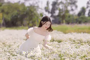 Ethereal Beauty: Young Woman in White Dress with Bouquet Amidst Dreamy Clouds - image 9