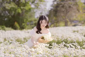 Ethereal Beauty: Young Woman in White Dress with Bouquet Amidst Dreamy Clouds - image 3