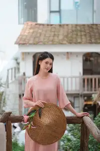 Discover Serene Vietnamese Beauty: Elegant Woman in Pink Linen Dress Amidst Floral Charm - image 6