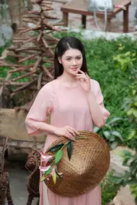 Discover Serene Vietnamese Beauty: Elegant Woman in Pink Linen Dress Amidst Floral Charm - image 5