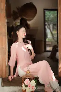 Discover Serene Vietnamese Beauty: Elegant Woman in Pink Linen Dress Amidst Floral Charm - image 2