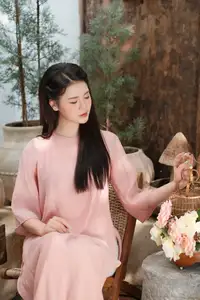 Discover Serene Vietnamese Beauty: Elegant Woman in Pink Linen Dress Amidst Floral Charm - image 3