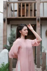 Discover Serene Vietnamese Beauty: Elegant Woman in Pink Linen Dress Amidst Floral Charm - image 1