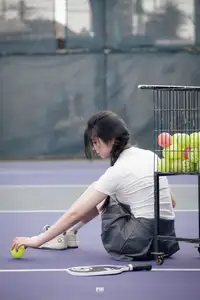 Pensive Break on Court: Young Tennis Player Recharges Energy After Intense Training Session - image 2