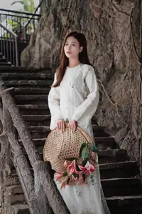 Elegant Vietnamese Beauty in White Ao Dai Serene Portrait with Pink Lilies on Ancient Stone Steps - image 0