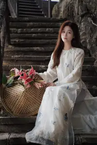 Elegant Vietnamese Beauty in White Ao Dai Serene Portrait with Pink Lilies on Ancient Stone Steps - image 2