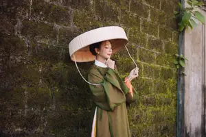 Timeless Vietnamese Charm: Elegant Girl in Traditional Attire and Nón Quai Thao - image 2