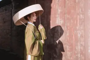 Timeless Vietnamese Charm: Elegant Girl in Traditional Attire and Nón Quai Thao - image 4
