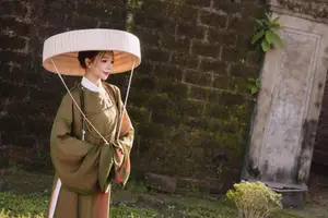 Timeless Vietnamese Charm: Elegant Girl in Traditional Attire and Nón Quai Thao - image 6
