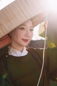 Timeless Vietnamese Charm: Elegant Girl in Traditional Attire and Nón Quai Thao - image 1