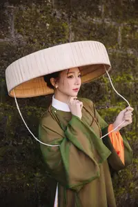 Timeless Vietnamese Charm: Elegant Girl in Traditional Attire and Nón Quai Thao - image 10