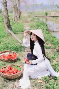 Elegant Vietnamese Student in Ao Dai Amidst Bauhinia Flowers - image 6