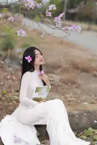 Elegant Vietnamese Student in Ao Dai Amidst Bauhinia Flowers - image 8