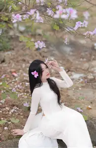 Elegant Vietnamese Student in Ao Dai Amidst Bauhinia Flowers - image 1
