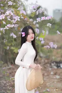 Elegant Vietnamese Student in Ao Dai Amidst Bauhinia Flowers - image 0